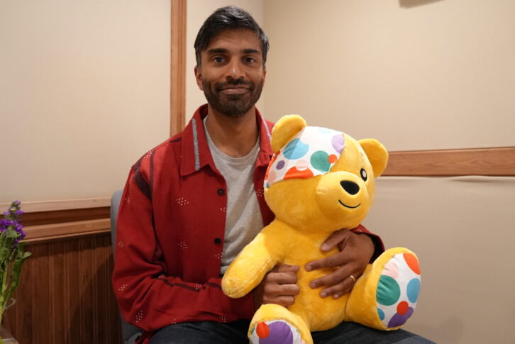 Actor Nikesh Patel poses for a photo with a cuddly Pudsey bear